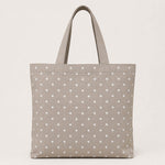 Canvas with white polka dots on a beige background - Ribes y Casals